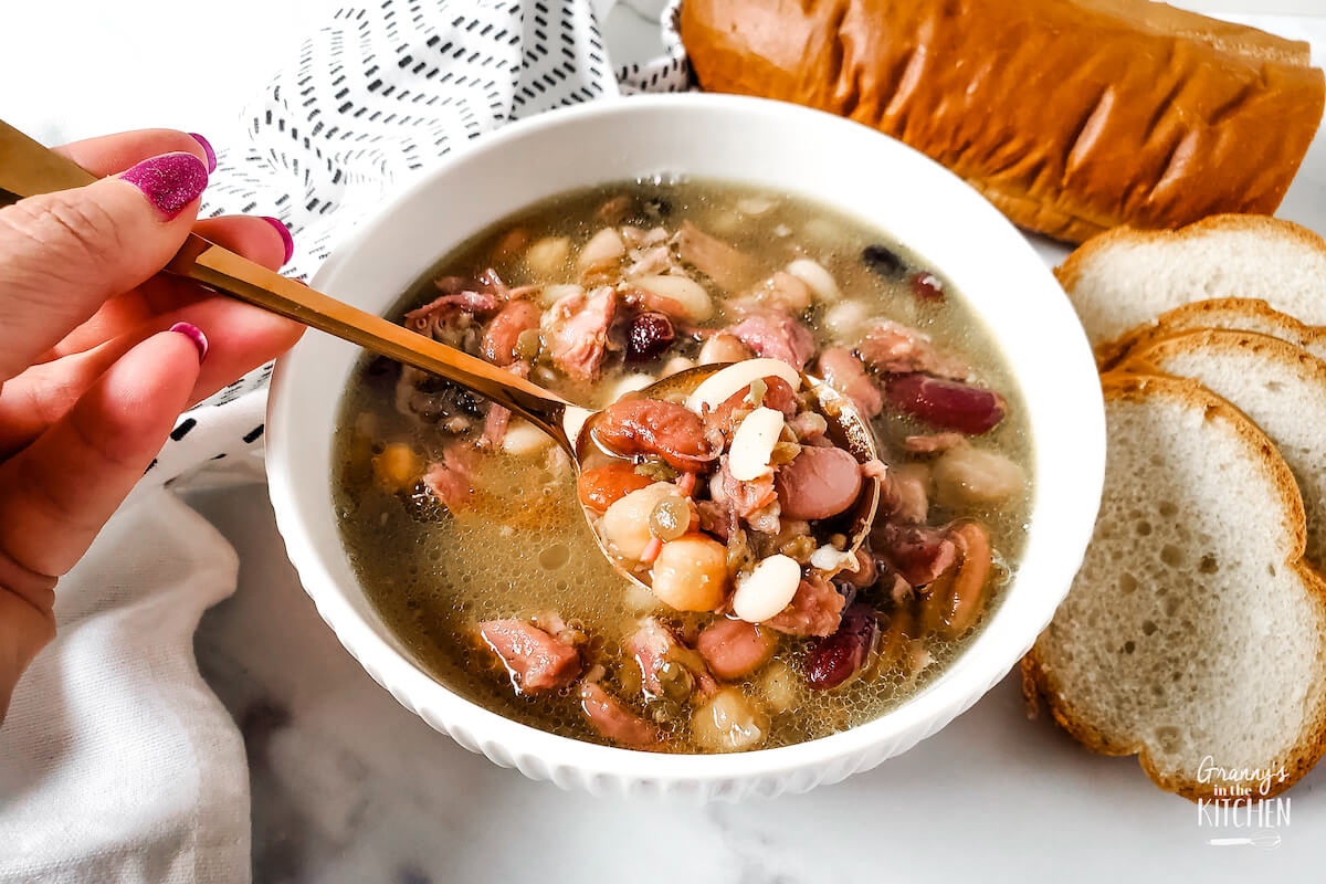 scooping ham and bean soup with a spoon