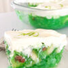 close up of a slice of green jello salad; text overlay "7-up salad"