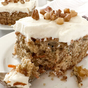 a piece of carrot cake with a bite taken