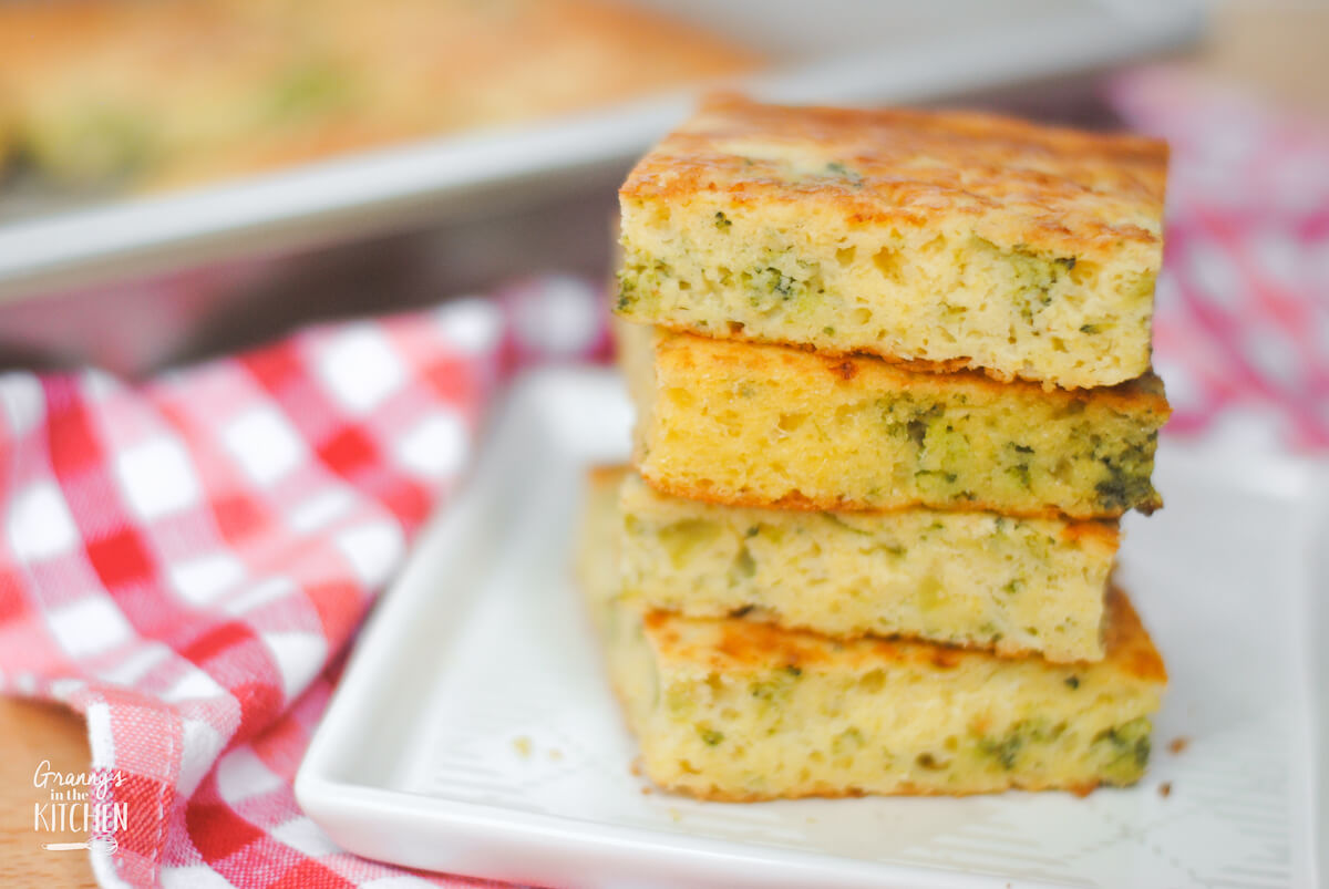 stack of 4 slices of broccoli cornbread, with pan in background