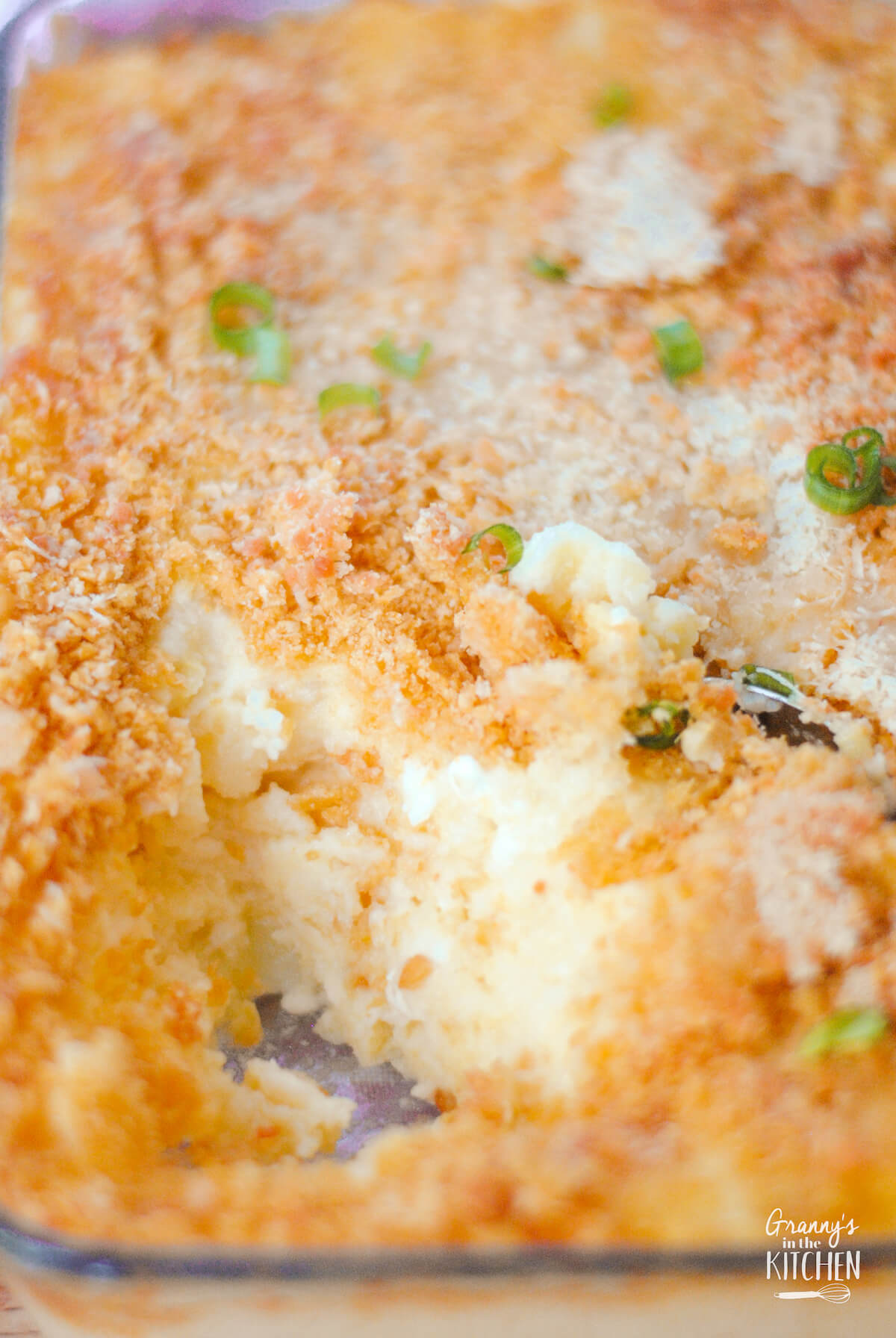 baked mashed potato casserole with a scoop missing.
