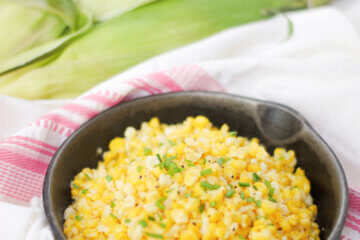 skillet of fried corn, with corn cobs in background; text overlay "Southern Fried Corn"