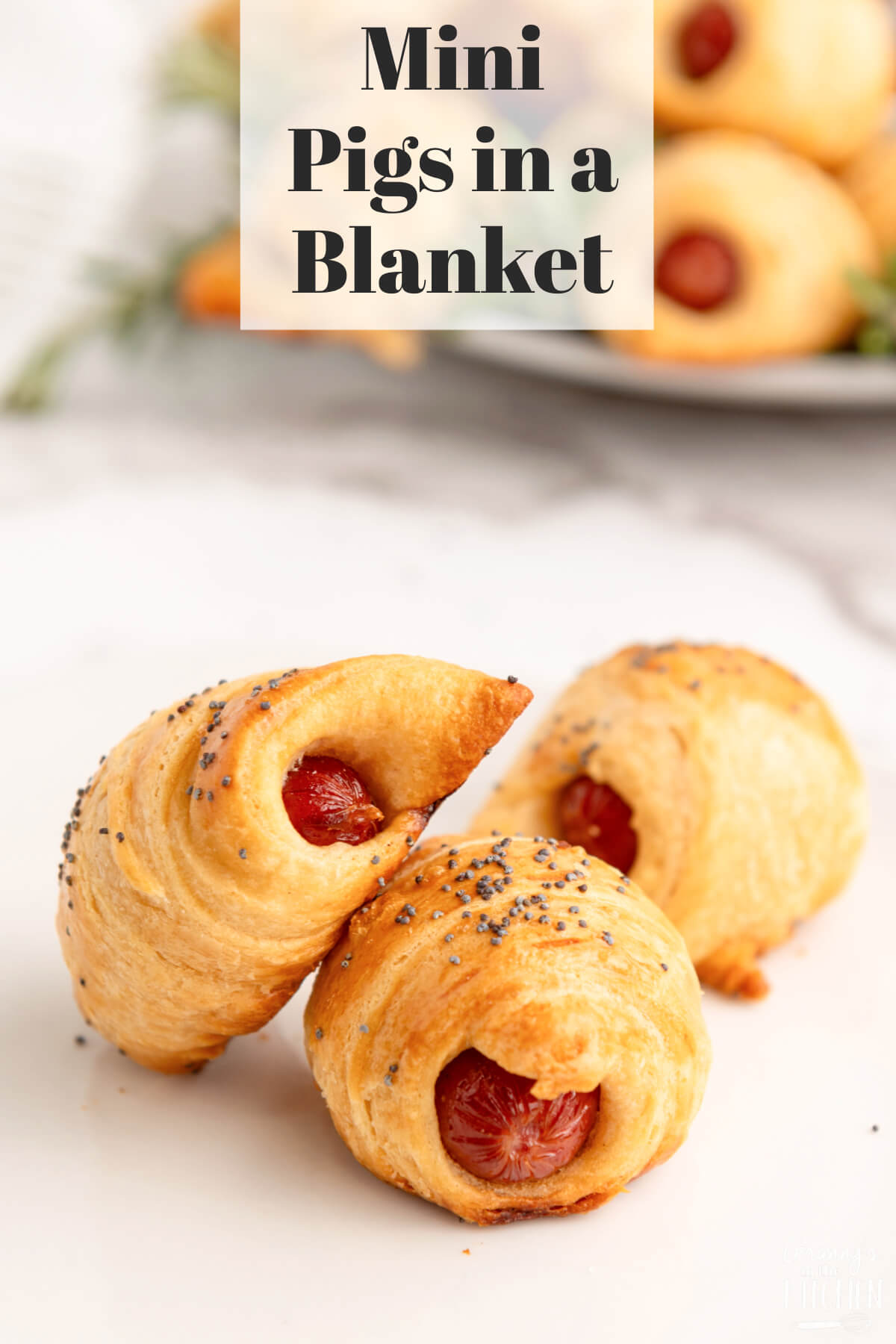close up of 3 mini pigs in a blanket, with text overlay of recipe name