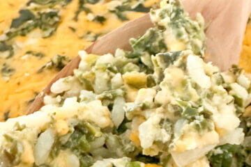 close up of a spoonful of spinach rice casserole, with text overlay of recipe name.