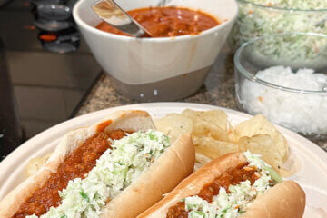 two hot dogs topped with chili and slaw, text overlay "West Virginia Hot Dogs".