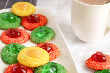 red, green, and gold sugar-coated thumbprint cookies, text overlay "Christmas Thumbprint Cookies".