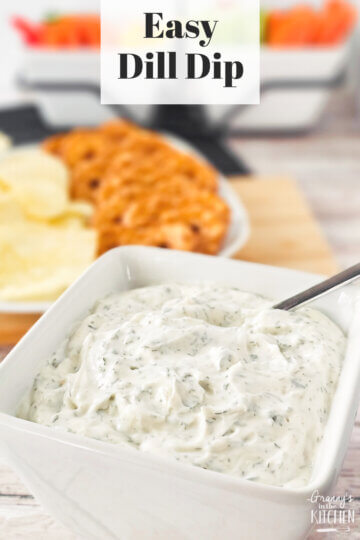 bowl of dill dip with chips and pretzels in background; text overlay "Easy Dill Dip".
