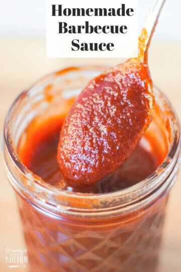 jar of homemade bbq sauce with spoon; text overlay "Homemade Barbecue Sauce".