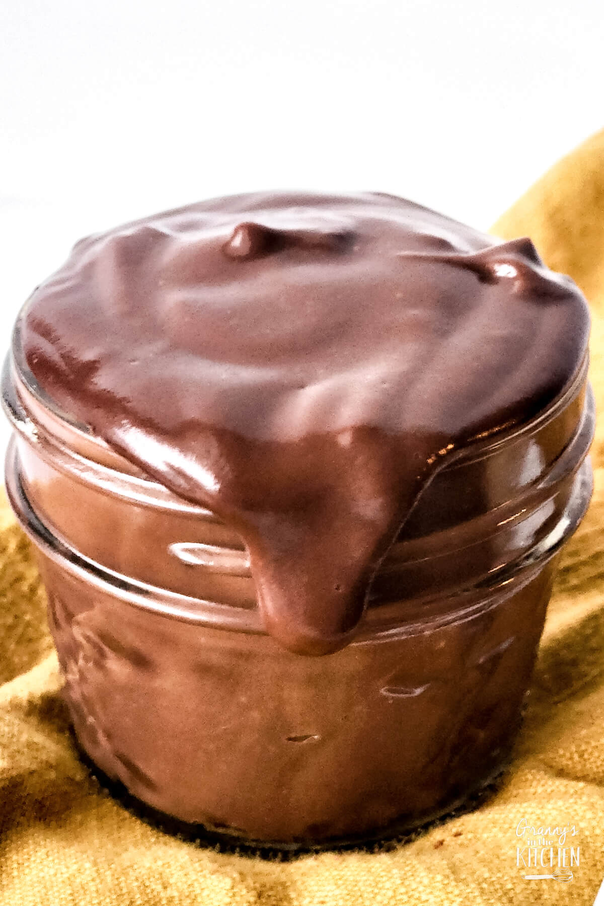 small mason jar full of homemade chocolate sauce.