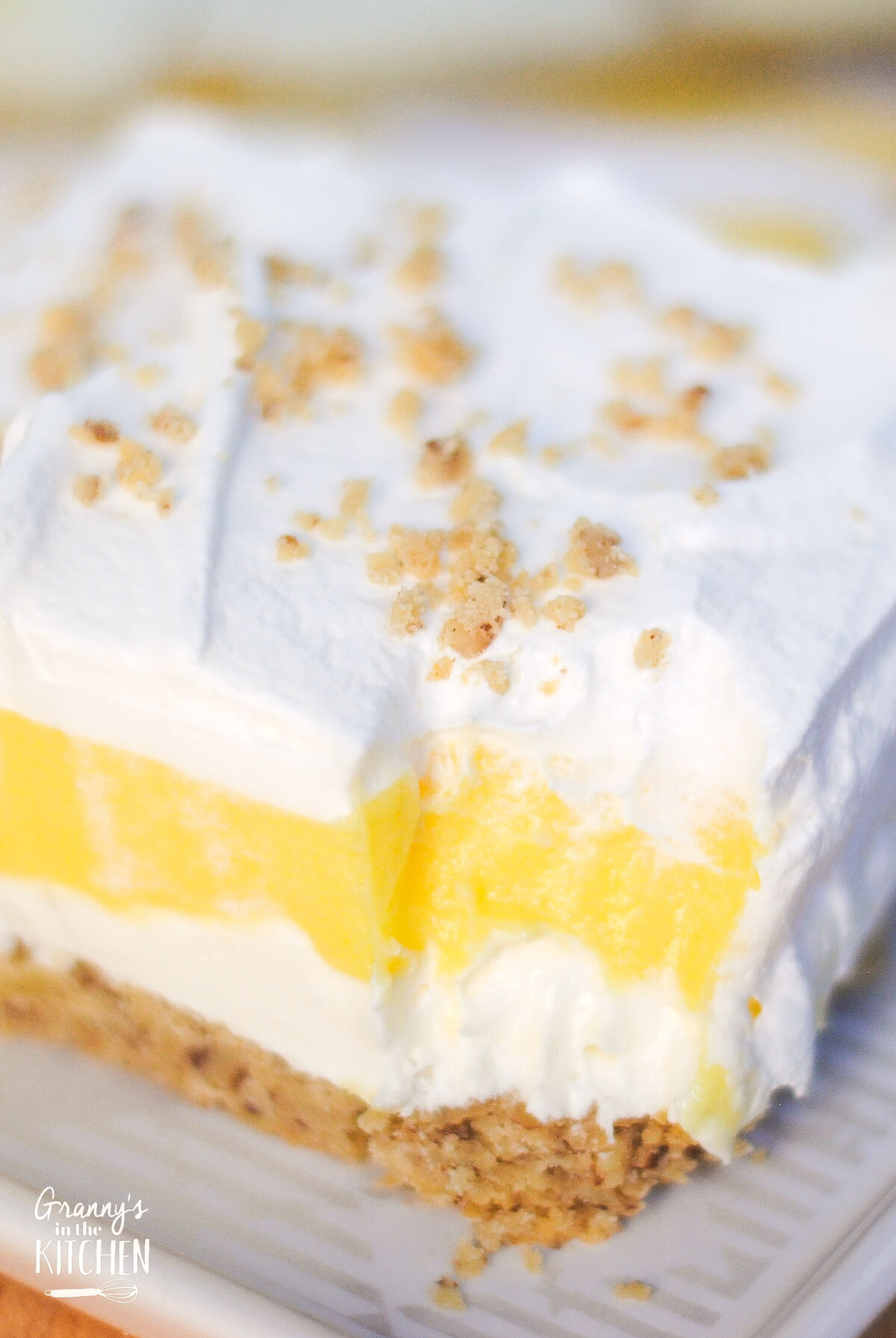 close up of lemon lush dessert with a bite missing.