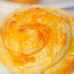 close up of orange sweet roll.