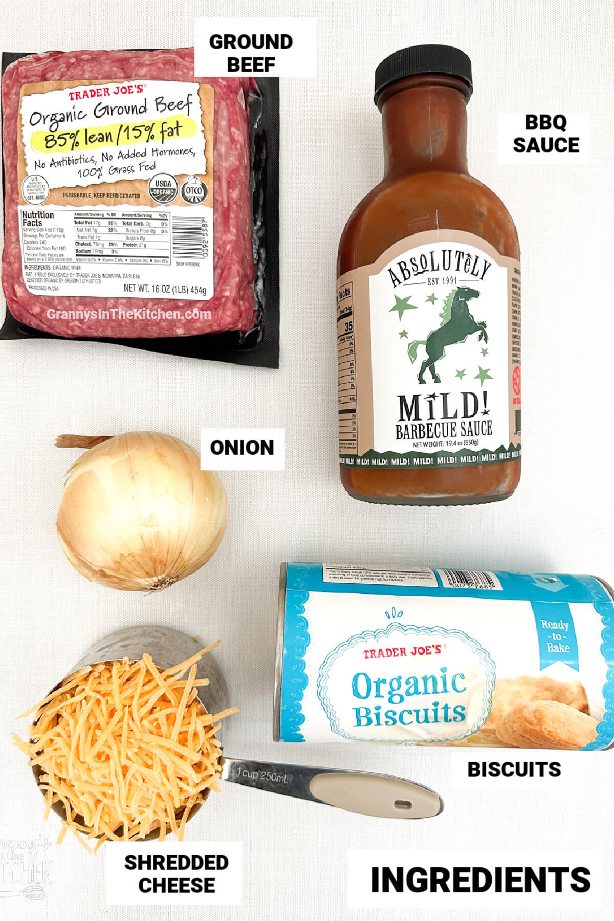 ingredients to make bbq biscuit cups, with text labels: bbq sauce, cheese, ground beef, onion, biscuits.