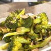 plate of sauteed broccoli with text overlay "Garlic Broccoli".