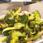 plate of sauteed broccoli with text overlay "Garlic Broccoli".