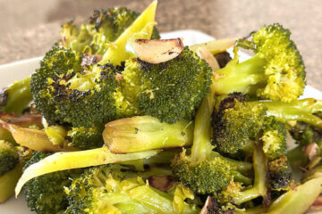 plate of sauteed broccoli with text overlay "Garlic Broccoli".