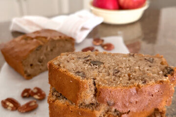 slices of homemade apple quick bread stacked on counter, with text overlay "Apple Bread".