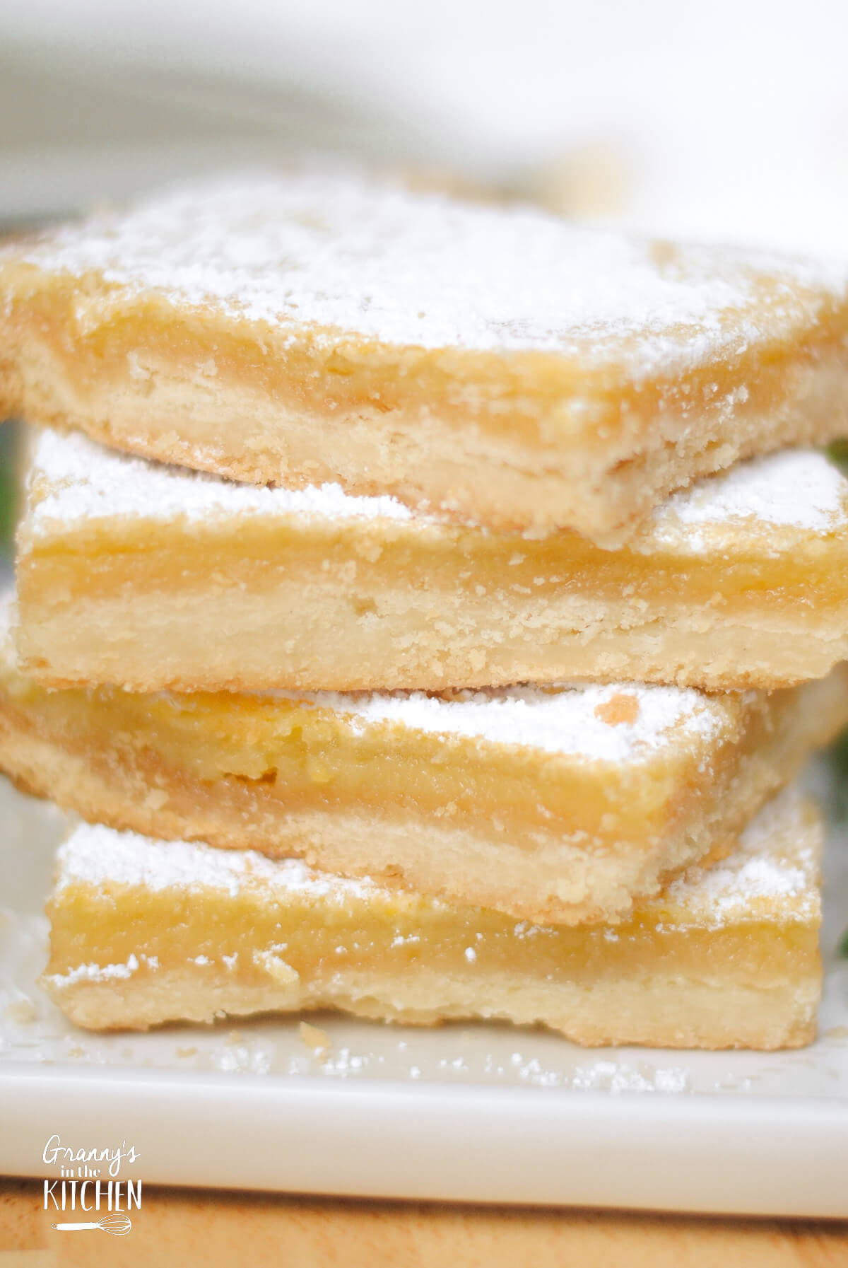 close up on a stack of 4 lemon squares.