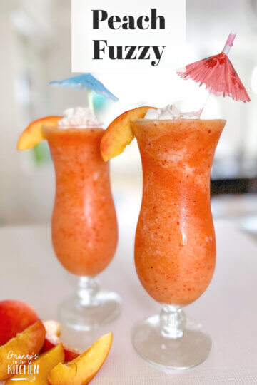 orange frozen drink in hurricane glasses; text overlay "Peach Fuzzy".