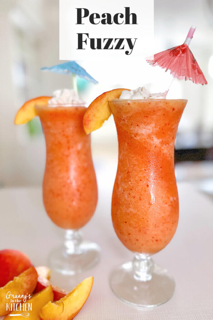 orange frozen drink in hurricane glasses; text overlay "Peach Fuzzy".