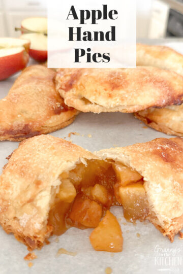 mini apple pie, cut in half to show filling, text overlay "Apple Hand Pies."