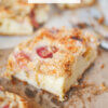 close up of a slice of rhubarb cake; text overlay "Rhubarb Buckle".