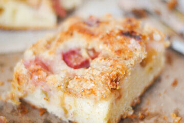 close up of a slice of rhubarb cake; text overlay "Rhubarb Buckle".