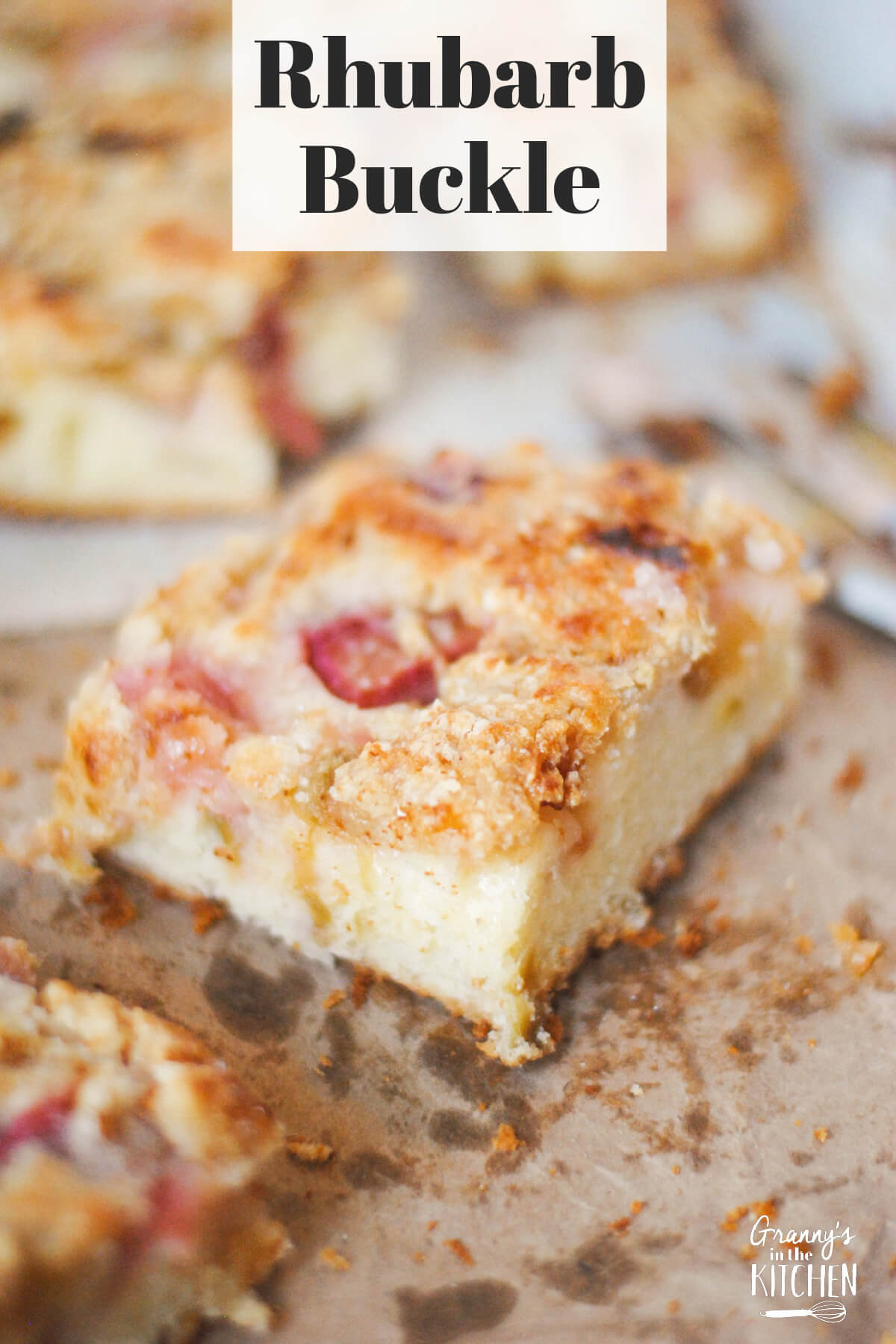 close up of a slice of rhubarb cake; text overlay "Rhubarb Buckle".