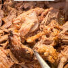 close up of shredded pork; text overlay "BBQ Pulled Pork".