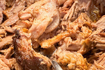 close up of shredded pork; text overlay "BBQ Pulled Pork".