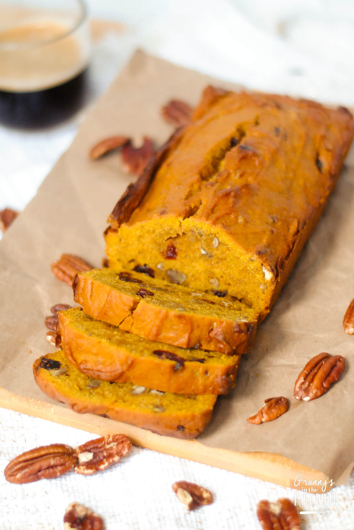 sliced loaf of pumpkin cranberry nut bread.