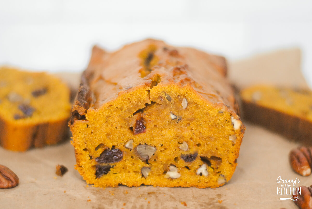 loaf of pumpkin cranberry bread, cut into to show detail.