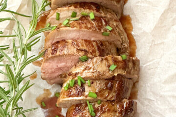 top down view of a sliced pork loin, text overlay "Marinated Pork Tenderloin".