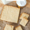 top down view of shortbread on parchment paper; text overlay "Scottish Shortbread."