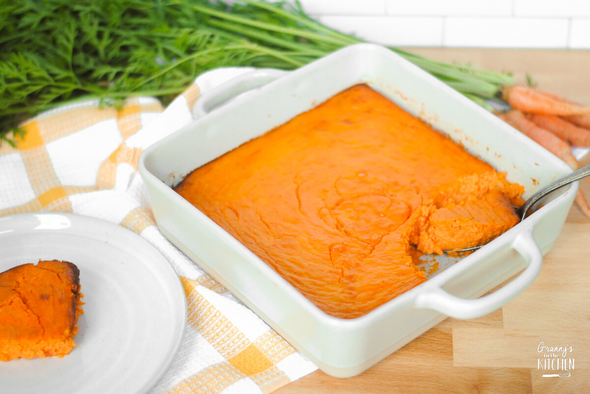 carrot Soufflé in baking dish and one serving on a smaller plate.