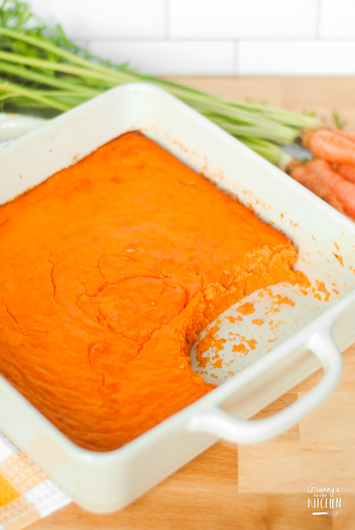 carrot casserole in pan with a scoop taken.