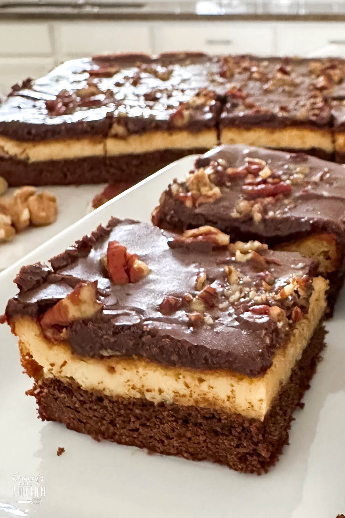 brownies with a layer of cheesecake and ganache.