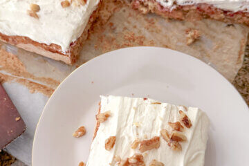 top down view of a soda cracker torte, with one slice on plate.
