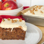 applesauce cake slice with full cake in background.