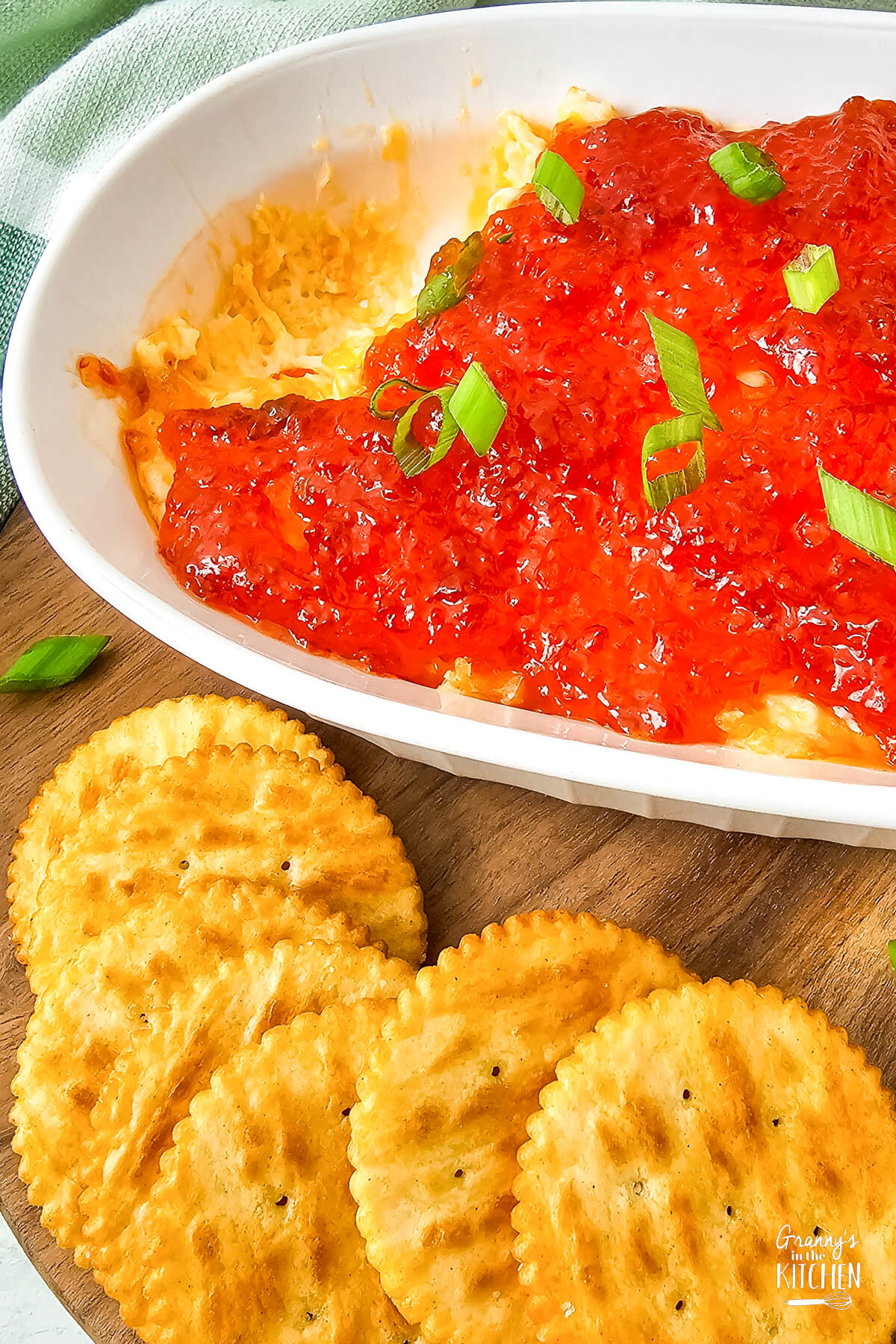 Red pepper cream cheese dip with crackers on the side