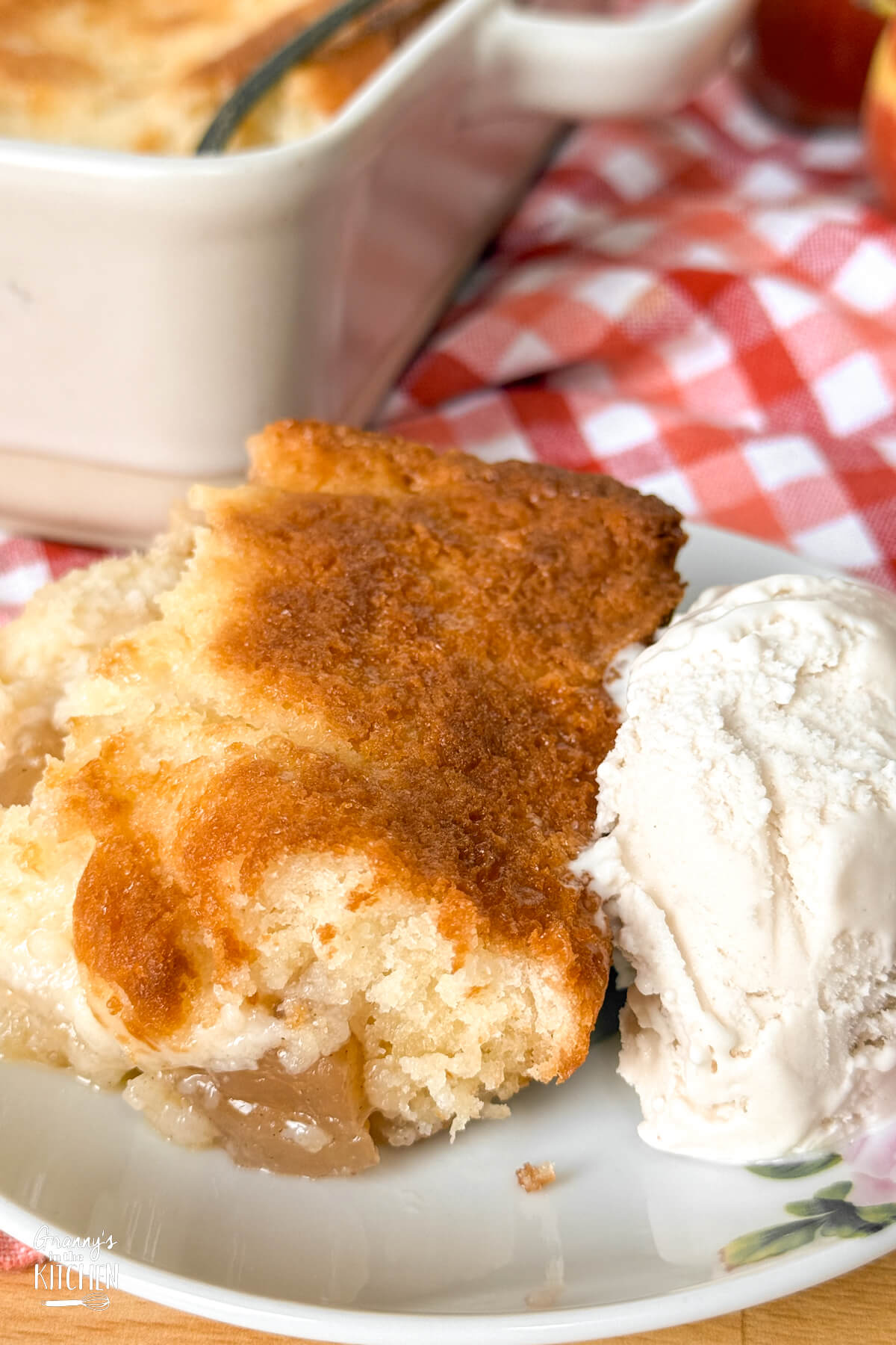 close up of a serving of homemade apple cobbler with ice cream.