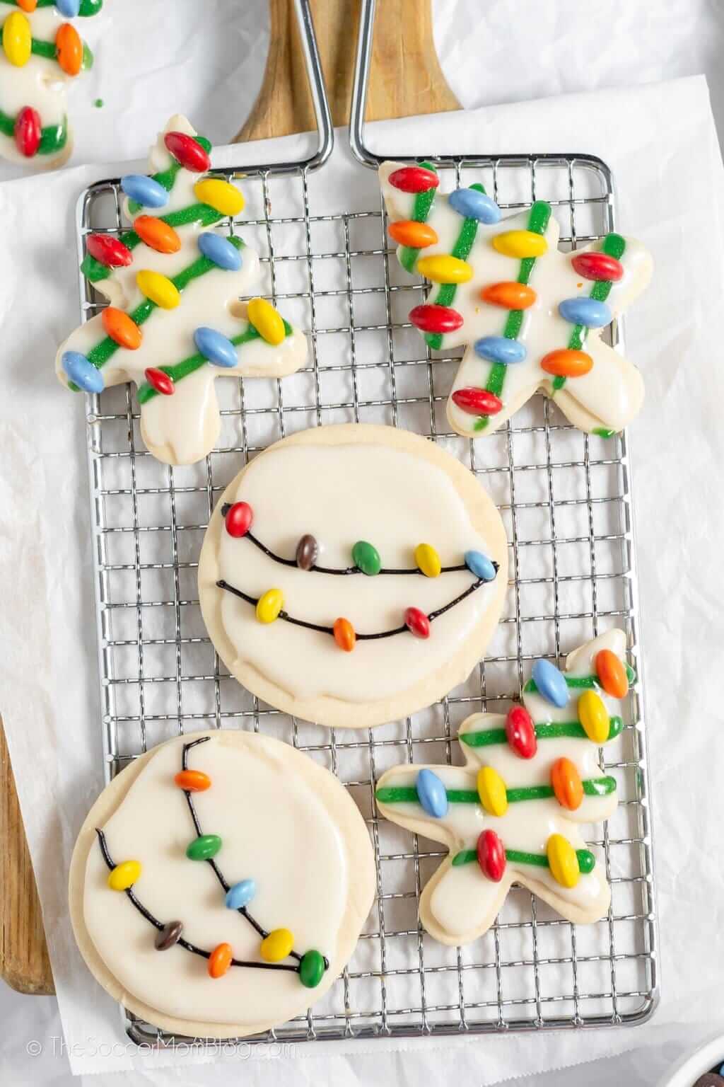 Five vintage christmas lights cookies on a wire cooling tray.