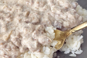 ground beef stroganoff served over rice, with recipe name text overlay.