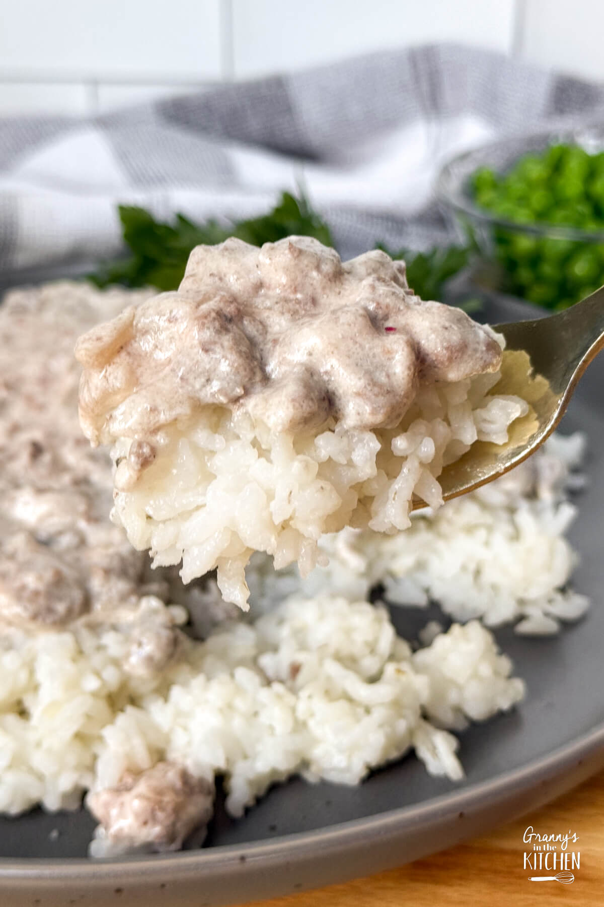 hamburger beef stroganoff on fork with rice.