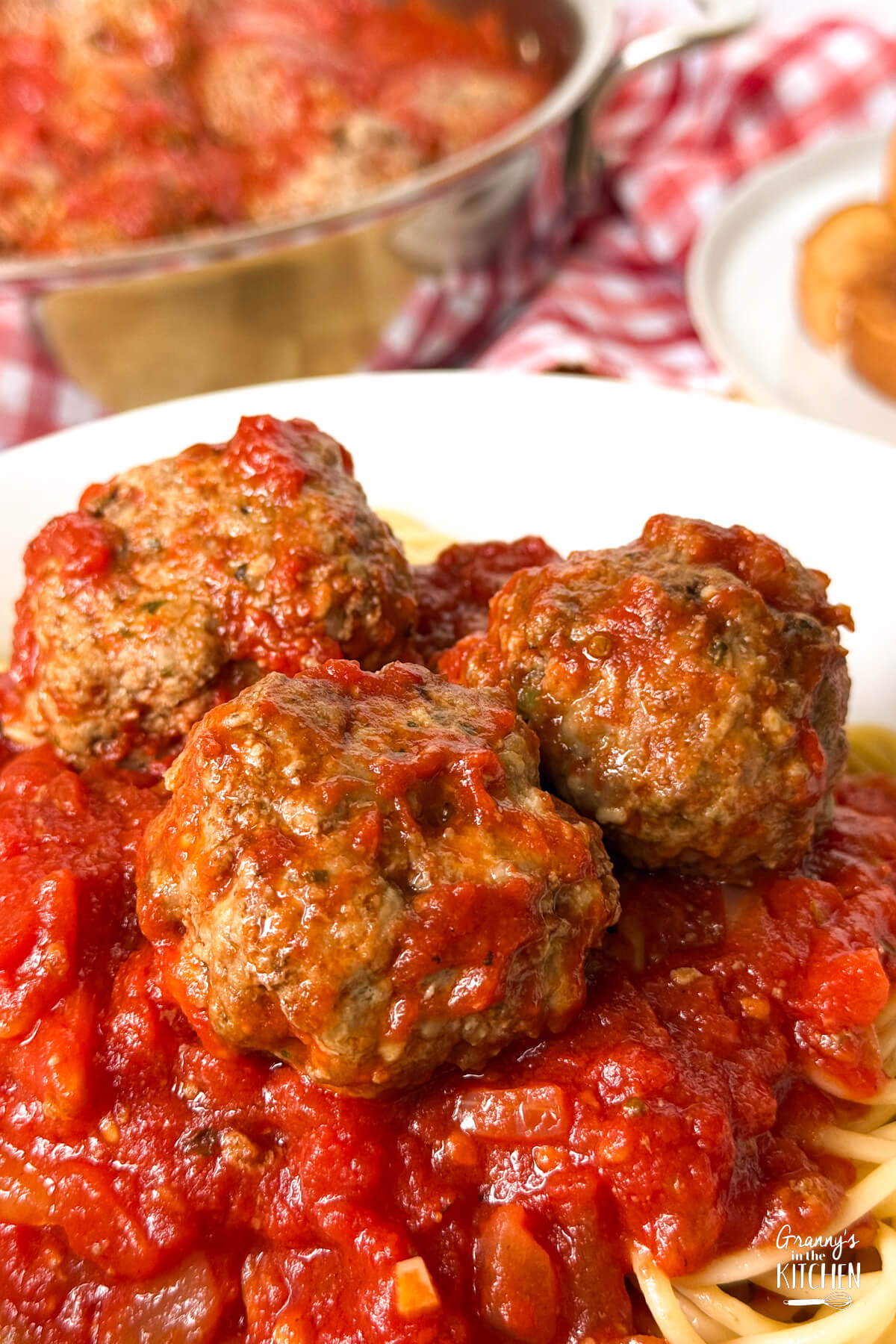 close up of a plate of spaghetti and meatballs.