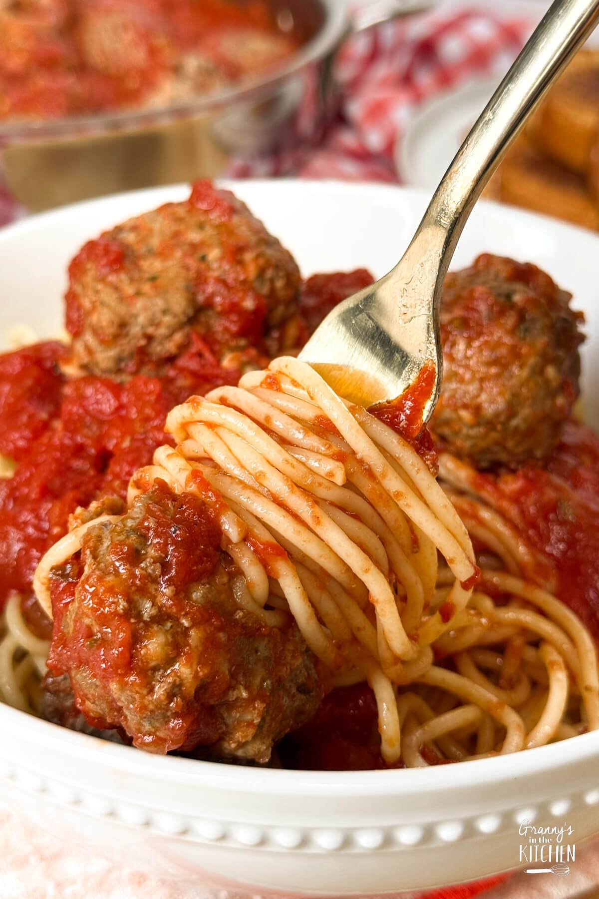 twirling spaghetti and a meatball on fork.