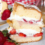 slice of strawberry chiffon cake standing up on a plate.