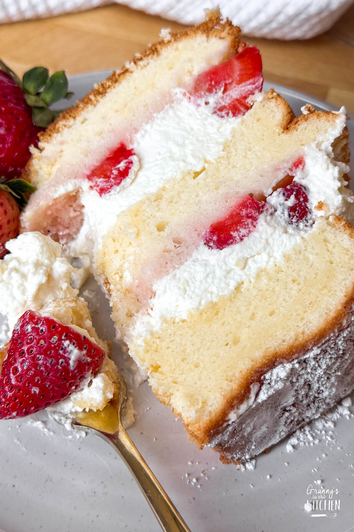 strawberry chiffon cake with a bite taken.