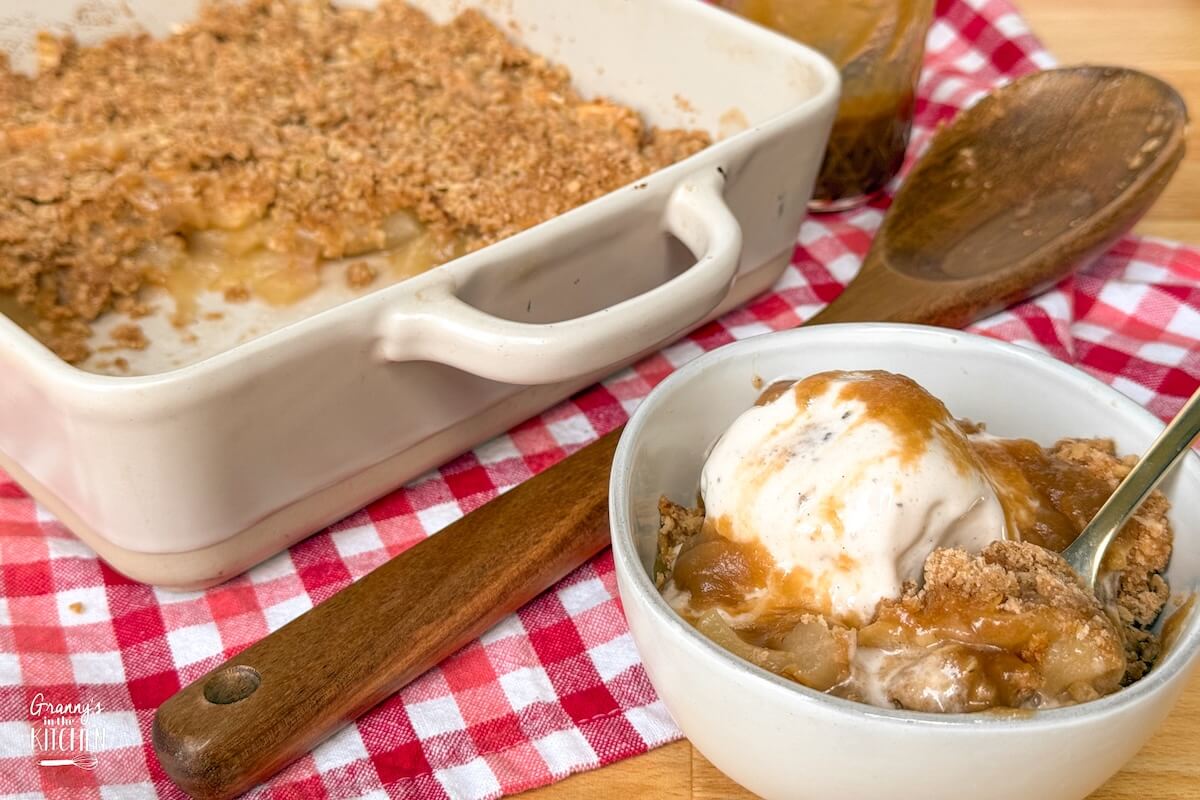 apple crisp in baking dish and in a bowl.