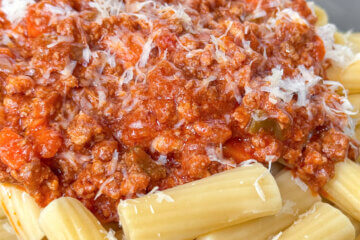 bowl of rigatoni with meat sauce, text overlay "Classic Bolognese Sauce."