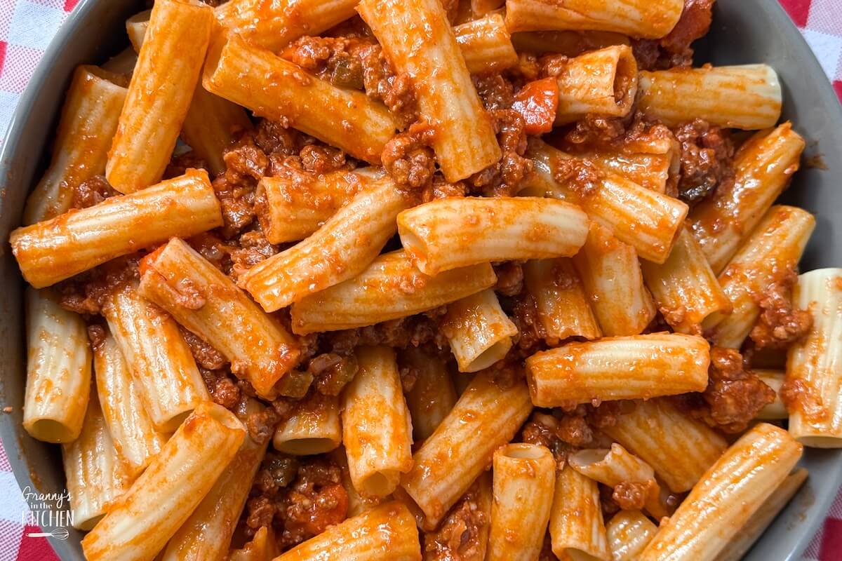 close up of a bowl of rigatoni bolognese.